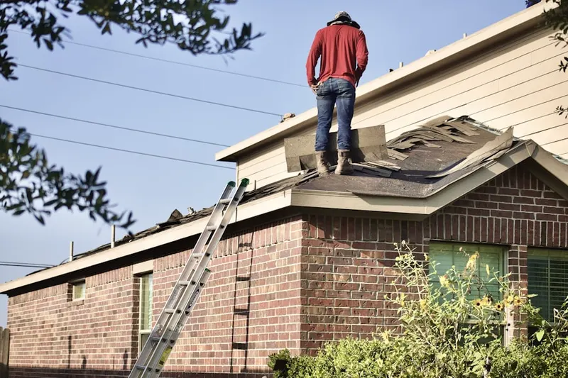 Professional roofer working on a residential roof in McNulty